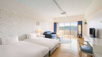 Habitación de hotel con dos camas, un escritorio, una silla, un televisor, un balcón con vistas y un techo estampado.