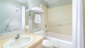 A bathroom with a sink, toilet, and shower area. - Super 8 Sheridan (Sheridan)