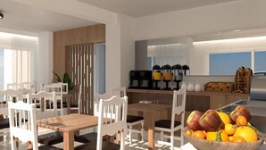 Cocina moderna con comedor, que incluye una cafetera, frutero y vistas a la ciudad.