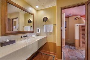 A bathroom with a large mirror, a sink, and a towel rack. - Hilton Grand Vacations Club Zihuatanejo (Zihuatanejo)