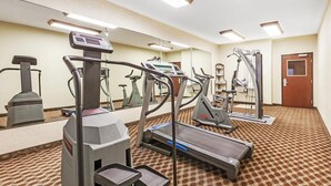 A hotel fitness center with treadmills, elliptical machines, and a stair climber. - Baymont by Wyndham Tyler (Tyler)