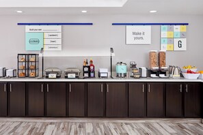 A buffet setup with labeled food stations including eggs, bacon, and whole milk. - Baymont by Wyndham Tyler (Tyler)