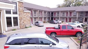 A multi-story building with a parking lot.