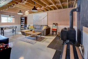 A cozy living room with a sofa, coffee table, and fireplace.