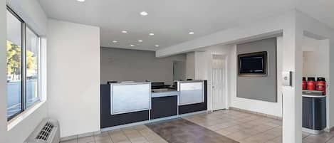 A modern kitchen with a large island, a built-in oven, and a microwave.
