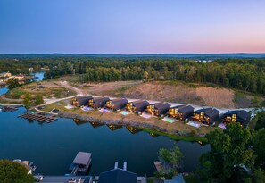 A waterfront property with multiple modern houses, a dock, and a lake. - The Great Escape - 1 (Hot Springs)