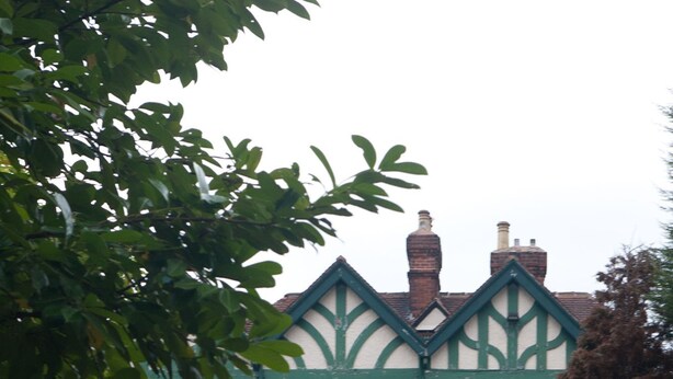 A brick building with a green and white facade, a sign reading 'STAINDROP HOTEL,' and a small porch with a bench. - Staindrop Lodge Hotel (Sheffield)