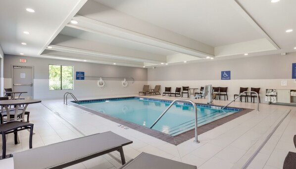 A swimming pool with lounge chairs and tables, a lifeguard stand, and a wheelchair-accessible sign. - Best Western Plus Choctaw Inn & Suites (Choctaw)