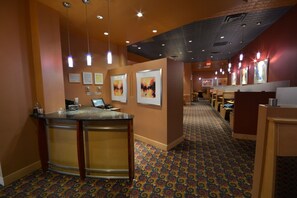 A hotel lobby with a reception desk, bar area, and seating. - Ihotel & Conference Centre Red Deer (Red Deer)
