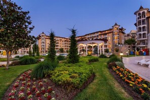 A hotel with multiple floors, outdoor seating, and landscaped gardens. - Royal Sun Holiday Complex (Nessebar)