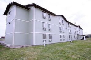 A multi-story building with a flat roof, large windows, and a flat facade. - Super 8 by Wyndham Omaha SW (Omaha)