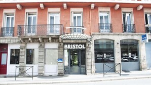 A hotel named 'BRISTOL' with a classic facade, large windows, and a prominent entrance. - The Originals City, Hotel Bristol, Le Puy-en-velay (Le Puy-en-Velay)