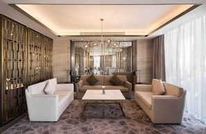 A modern living room with a sofa set, a coffee table, and a decorative wall panel. - Aber Unaiza (Unaizah)
