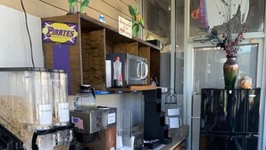 A compact kitchen with a coffee machine, microwave, and refrigerator. - Motel6 Greenville, NC Ecu-medical Center (Greenville)