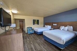 A hotel room with two beds, a desk, a television, and a chair. - Days Inn by Wyndham Gainesville University (Gainesville)