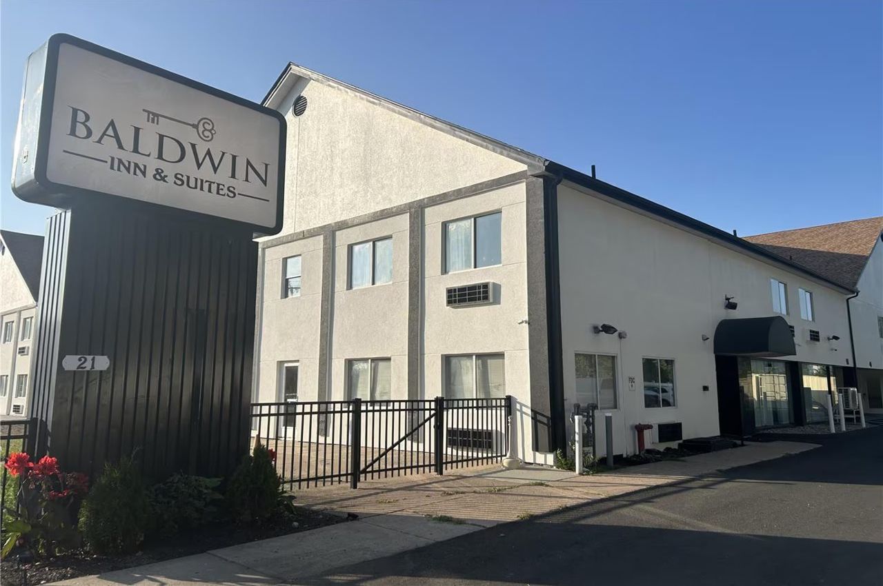 A building with a sign reading 'Baldwin Inn & Suites.'