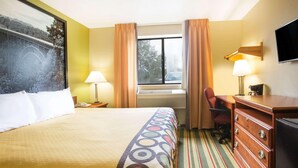 A hotel room with a bed, a desk, a chair, a TV, and a window with curtains. - Super 8 Beckley (Beckley)