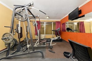 A gym with exercise equipment, a treadmill, and a mirrored wall. - Americas Best Value Inn Schulenburg (Schulenburg)
