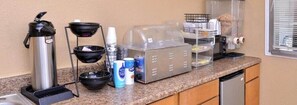 A kitchenette with a coffee maker, a kettle, a microwave, a toaster, and a refrigerator. - Americas Best Value Inn Schulenburg (Schulenburg)