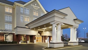A Country Inn & Suites building with a covered entrance, columns, and a brick facade. - Country Inn & Suites By Radisson Evansville IN (Evansville)