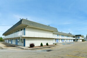 A motel with a two-story structure, a parking lot, and a clear sky. - Motel6 Topeka, KS - Northwest (Topeka)