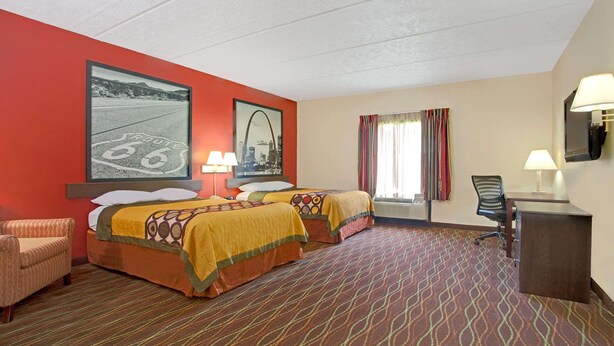 A hotel room with two beds, a desk, a chair, and a TV. - Super 8 by Wyndham Canton (Canton)
