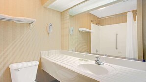 A modern bathroom with a large mirror, white sink, and toilet. - Super 8 by Wyndham Canton (Canton)