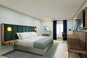 A modern hotel room with a large bed, a desk, and a TV. - Wingate by Wyndham Augusta I-20 (Augusta)