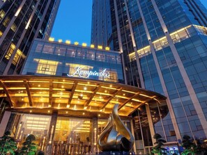 A modern hotel with a prominent 'Kempinski' sign, large glass windows, and a distinctive sculpture in front. - Kempinski Hotel Changsha (Changsha)