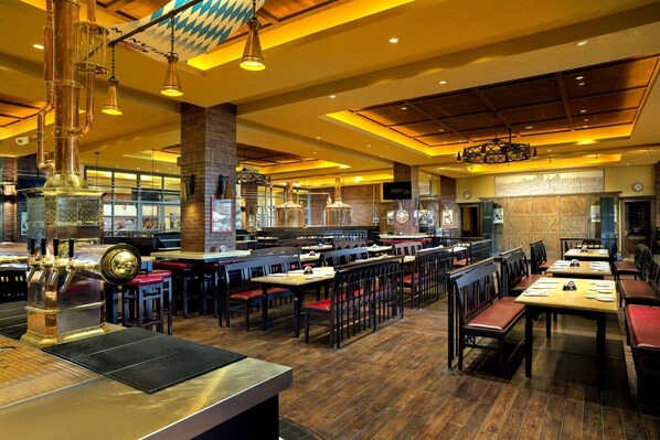 A spacious restaurant with high ceilings, exposed brick walls, and a variety of seating arrangements. - Kempinski Hotel Changsha (Changsha)