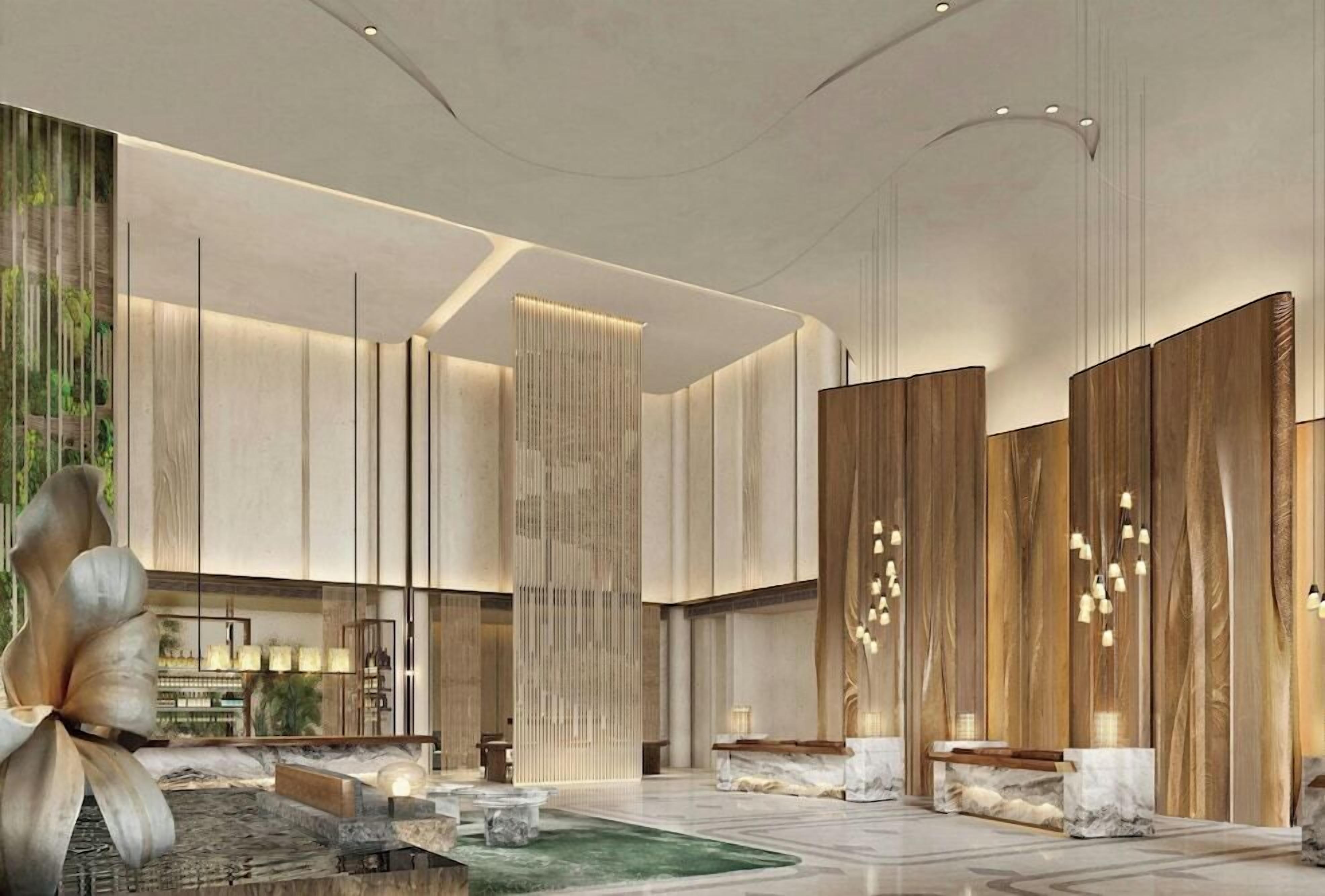 A modern lobby with a central seating area, vertical wooden panels, and a large abstract sculpture.