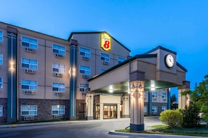 A Super 8 hotel with a clock tower, multiple windows, and a covered entrance. - Red Deer City Centre (Red Deer)