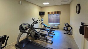 A gym with cardio equipment, a television, and a water dispenser. - Comfort Inn & Suites Beeville, TX (Beeville)