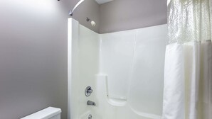 A bathroom with a bathtub, a shower, and a toilet. - Delavan Inn and Suites (Delavan)