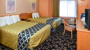 A hotel room with two beds, a desk, a chair, and a television. - Americinn by Wyndham Rawlins (Rawlins)