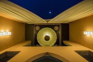 A room with a central decorative wall, recessed lighting, and a ceiling with draped fabric. - Adam Park Marrakech Hotel & Spa (Marrakech)