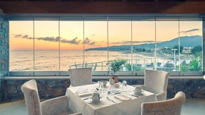A table set for dining with a view of the sea and mountains. - Ikaros Beach Luxury Resort and Spa - Adults Only (Hersonissos)