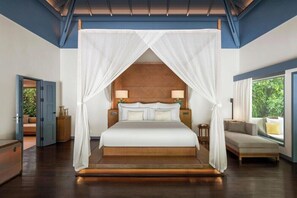 A bedroom with a canopy bed, a sofa, a window with a view, and a door leading to another room. - The Halcyon Private Isles Maldives (Meradhoo)