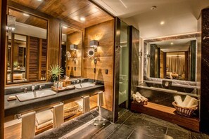 A modern bathroom with wooden paneling, dual sinks, and a large mirror. - Impression Moxché by Secrets Adults Only (Playa del Carmen)