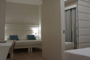 Una habitación de hotel con una cama, un escritorio y una silla.