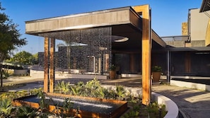 A modern building with a water feature in the foreground. - LUX Grand Baie Mauritius (Grand-Baie)