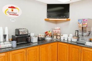 A kitchenette with a toaster, microwave, coffee maker, and cereal boxes. - Super 8 by Wyndham Watseka (Watseka)