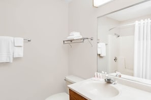 A bathroom with a white sink, mirror, and towel rack. - Super 8 by Wyndham Watseka (Watseka)