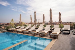 A rooftop pool with lounge chairs and umbrellas, surrounded by a cityscape. - Longue Vie Hotel Marrakech (Marrakech)
