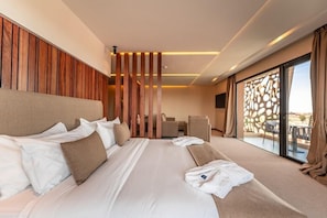 A hotel room with a large bed, a seating area, and a view through a glass door. - Longue Vie Hotel Marrakech (Marrakech)