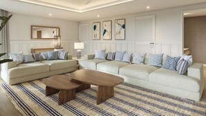 A modern living room with a sectional sofa, a coffee table, and a ceiling fan. - Secrets St. Lucia Resort & Spa Adults Only (Gros Islet)