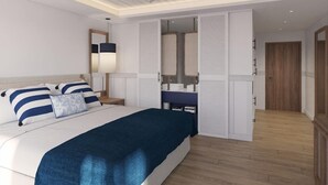 A bedroom with a bed, bedside table, mirror, wardrobe, and a bathroom with a sink and mirror. - Secrets St. Lucia Resort & Spa Adults Only (Gros Islet)