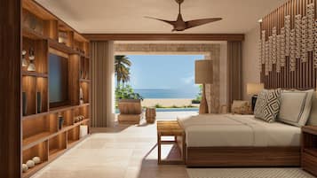 Quarto espaçoso com uma cama grande, um guarda-roupa de madeira, uma televisão e vista para o mar.