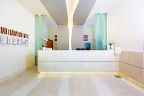 A reception area with a reception desk, framed certificates on the wall, and a reception sign. - Hotel Le Axidie, BW Signature Collection (Vico Equense)