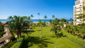 A resort with a beach view, palm trees, and a well-maintained lawn. - Best Western Jaco Beach All Inclusive Resort (Jacó)